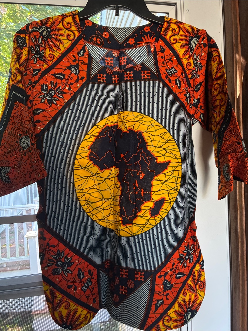 Ladies authentic African Print Short Sleeve Shirt in Orange & Yellow. Has slits